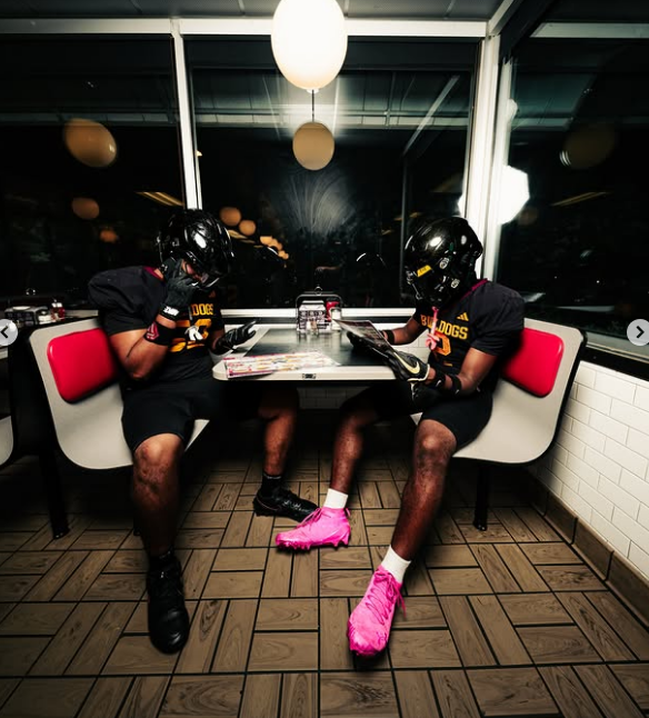 Two players sharing a booth, moody interior light