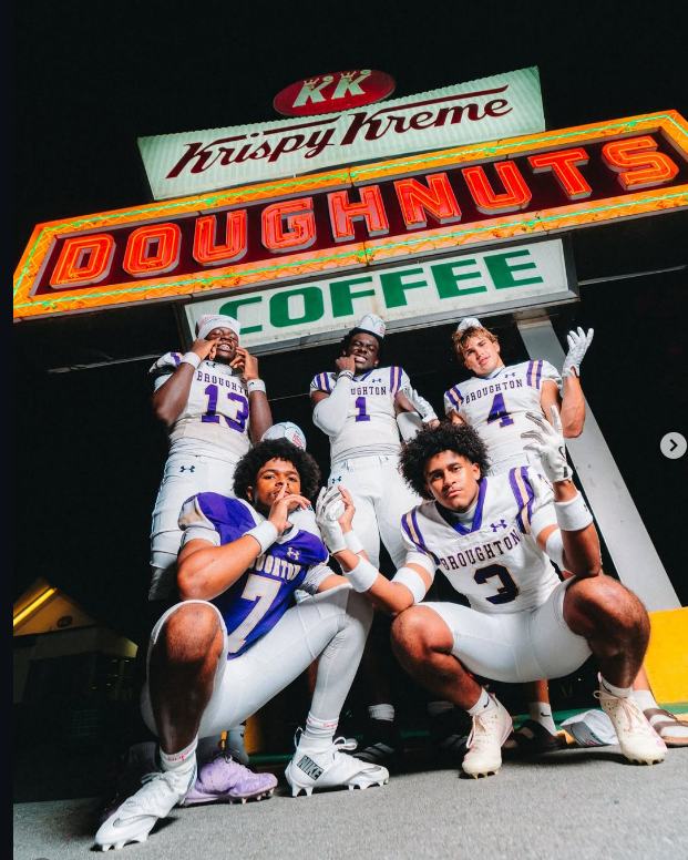 Squad under the neon doughnut shop marquee