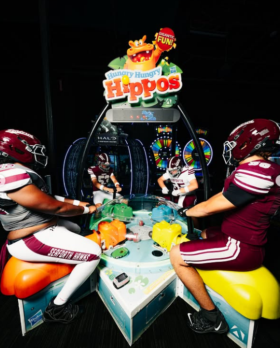 Arcade showdown — players facing off at a game table