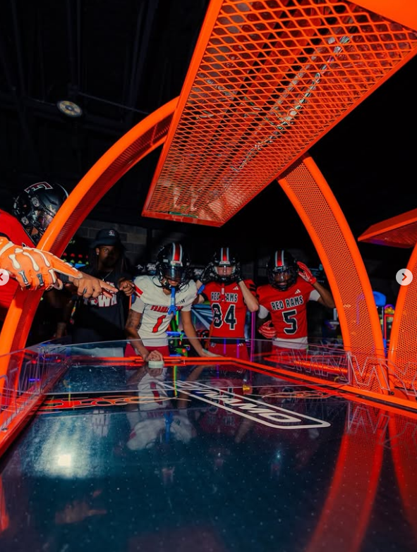 Air hockey under saturated neon light