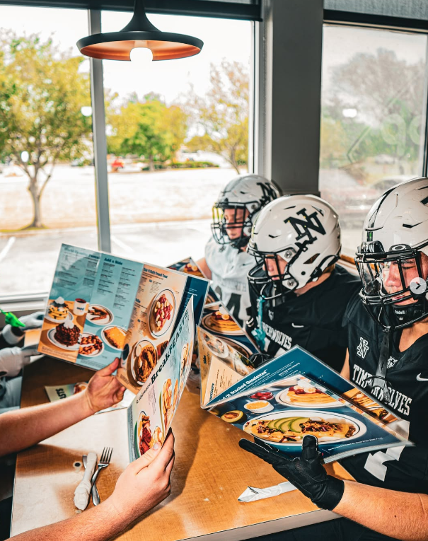 Helmets up, menus open in a window booth
