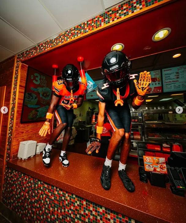 Two players perched on the front counter, gloves up